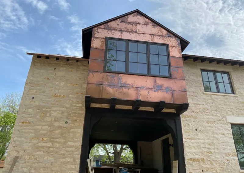 Copper metal panel facade on a stone building for Skylight Installation in Westlake