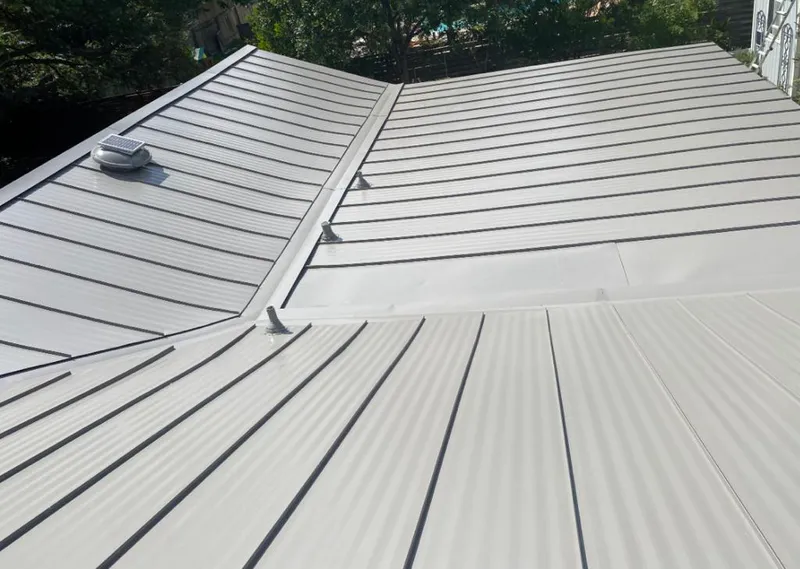 Solar attic fan installed on a metal roof for Roof Ventilation in Westlake